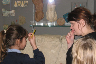 primary student and teacher studying artefacts alternative settings